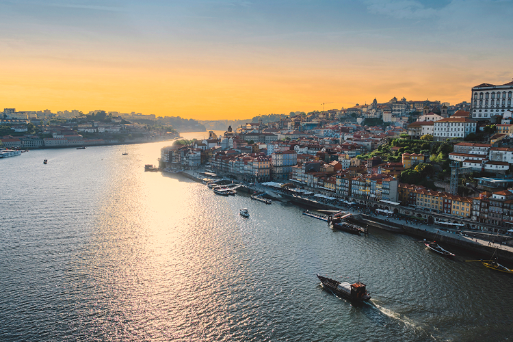 Rabelo boat from river sightseeing cruising the Douro river during the sunset